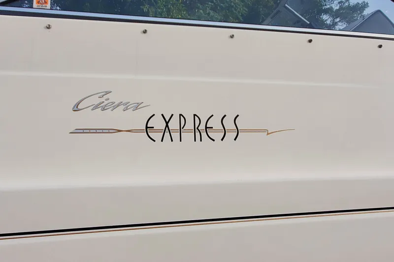 Slide: The Image of 1996 Bayliner 2252 Ciera Express boat logo on white hull. - 12
