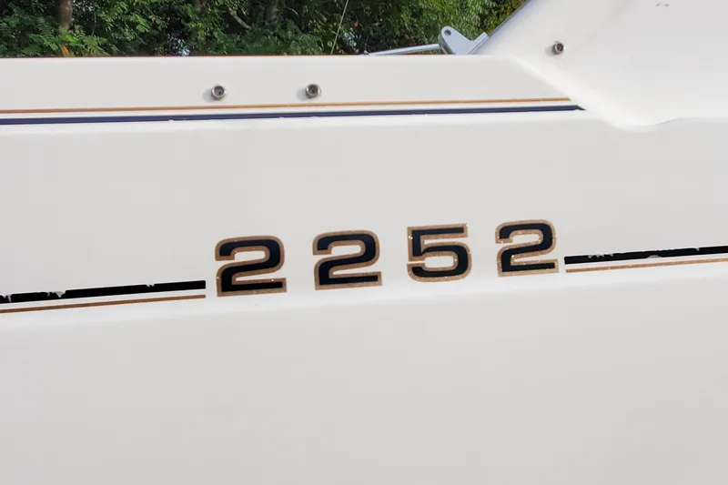 Slide: The Image of Bayliner 2252 Ciera Express boat, 1996 model, white hull with black and gold accents. - 13