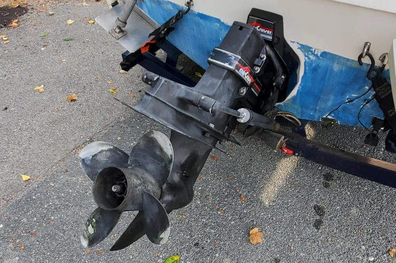 Slide: The Image of 1996 Bayliner 2252 Ciera Express boat propeller and outdrive on pavement. - 15