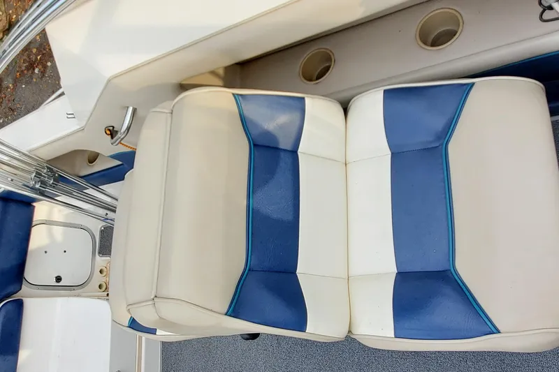 Slide: The Image of 1996 Bayliner 2252 Ciera Express boat interior with blue and white seating. - 16