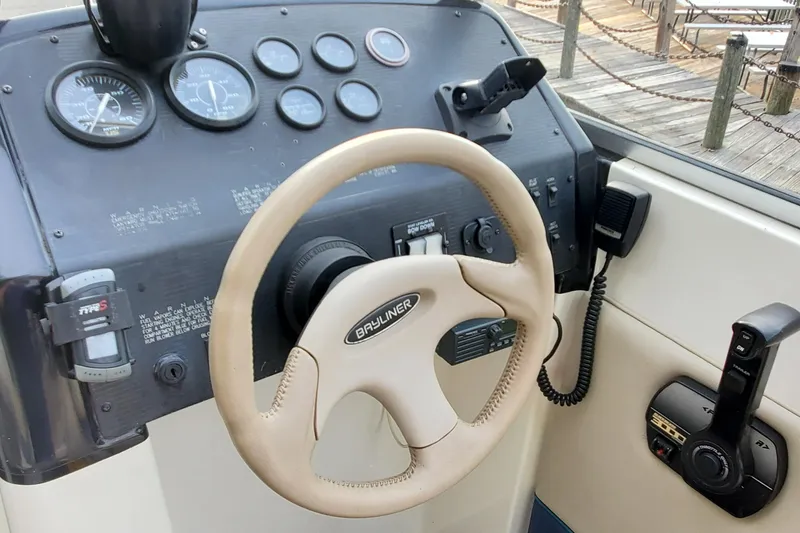 Slide: The Image of 1996 Bayliner 2252 Ciera Express dashboard with steering wheel and control panel. - 18
