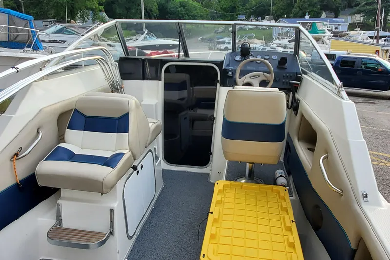 Slide: The Image of 1996 Bayliner 2252 Ciera Express boat interior with seating and steering wheel. - 26