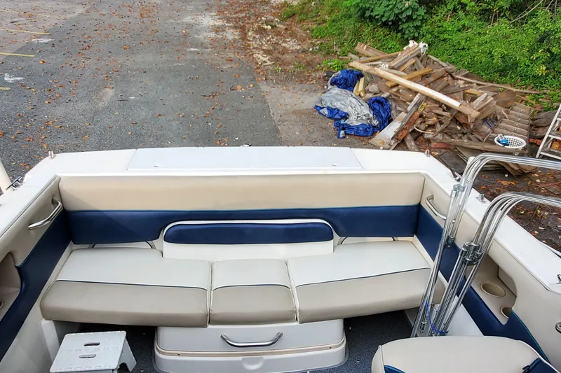 Slide: The Image of 1996 Bayliner 2252 Ciera Express boat interior with blue and white seating. - 28