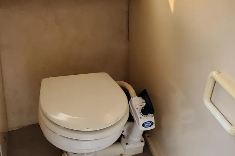 Slide: The Image of 1996 Bayliner 2252 Ciera Express marine toilet with manual pump handle. - 29