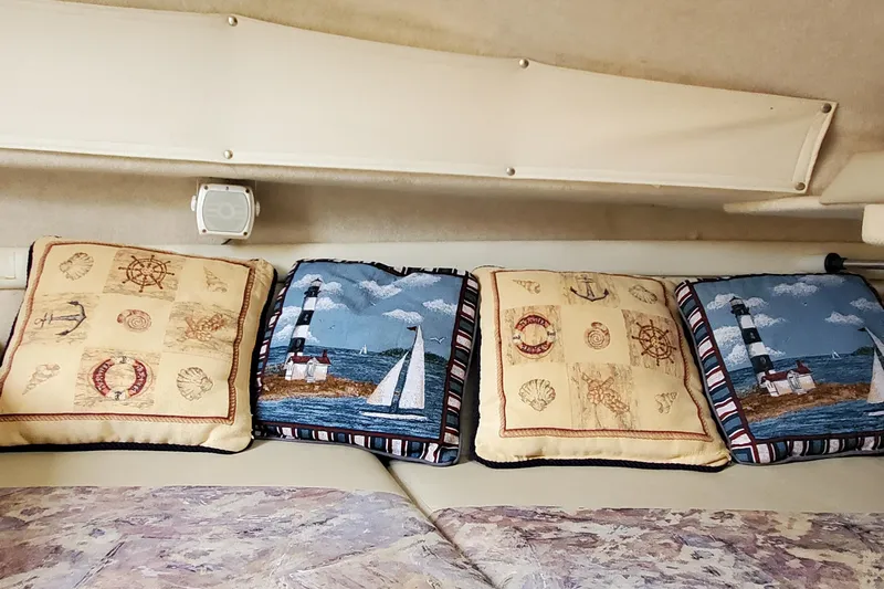 Slide: The Image of Nautical-themed cushions inside a 1996 Bayliner 2252 Ciera Express boat cabin. - 32