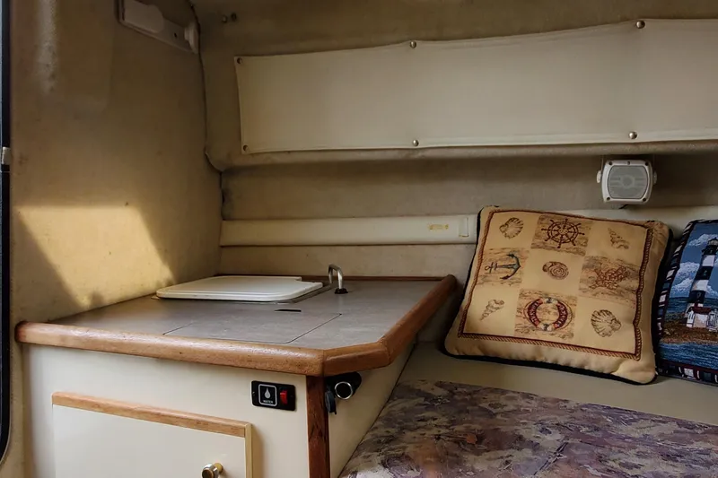 Slide: The Image of Interior of a 1996 Bayliner 2252 Ciera Express with cozy cabin and nautical-themed decor. - 33