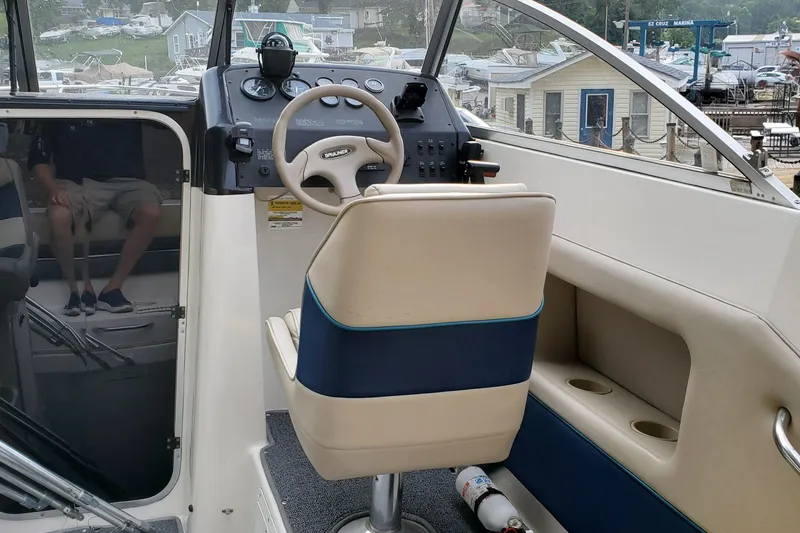 Slide: The Image of 1996 Bayliner 2252 Ciera Express boat cockpit with steering wheel and control panel. - 35