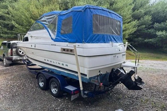 Slide: The Image of 1996 Bayliner 2252 Ciera Express boat on trailer, blue canopy, parked outdoors. - 41