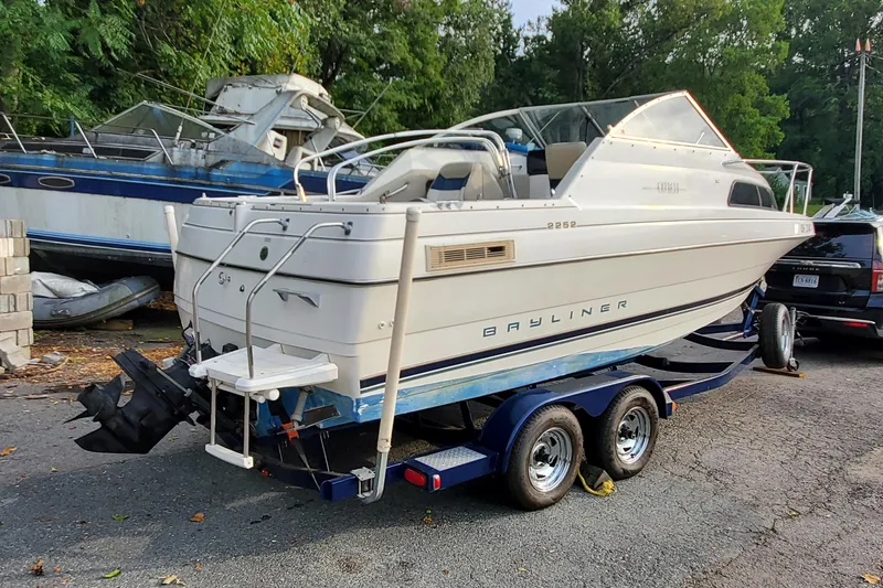 Slide: The Image of 1996 Bayliner 2252 Ciera Express boat on trailer, parked outdoors. - 9
