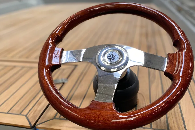 Slide: The Image of Wooden steering wheel of Black Pepper Tender 17, 2026 model, on a wooden deck. - 5