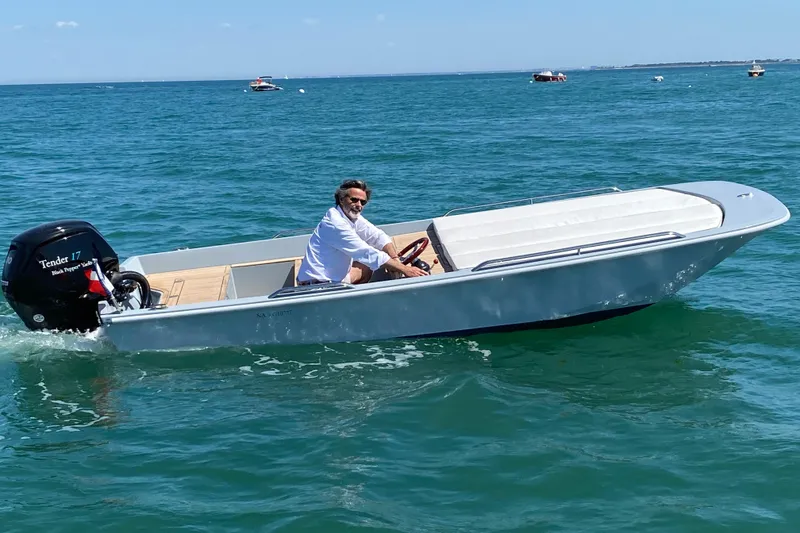 Slide: The Image of Man piloting Black Pepper Tender 17 boat on open water, 2026 model. - 8
