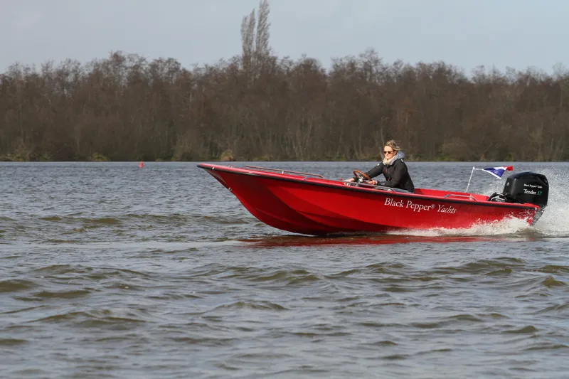 Slide: The Image of Red Black Pepper Tender 17 boat cruising on a lake, 2026 model. - 14
