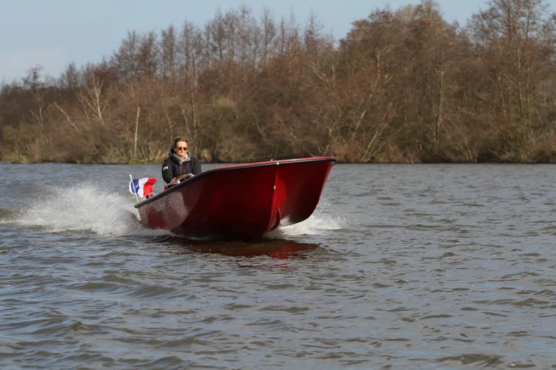 Slide: The Image of Red Black Pepper Tender 17 boat cruising on a lake, 2026 model. - 12