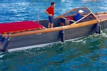 Slide: The Image of 2026 Black Pepper Tender 24 boat cruising on blue water with two passengers. - 8