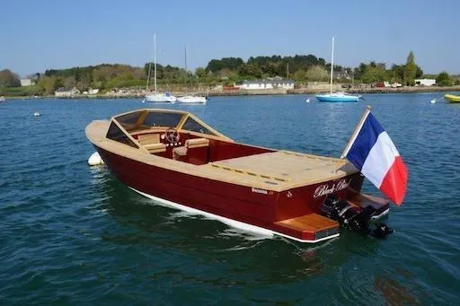 Slide: The Image of Elegant Black Pepper Tender 24 boat, 2026 model, with French flag on serene water. - 19