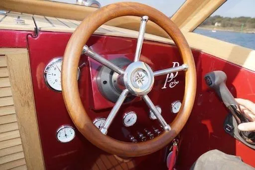 Slide: The Image of Steering wheel of 2026 Black Pepper Tender 24 boat with gauges and controls. - 18