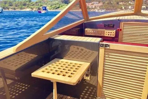 Slide: The Image of 2026 Black Pepper Tender 24 boat interior with wooden accents on a sunny day. - 6