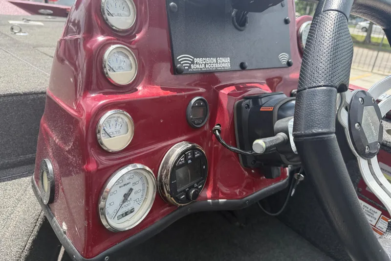 Slide: The Image of Dashboard of a 2021 SeaArk BC 210 boat with gauges and steering wheel. - 13