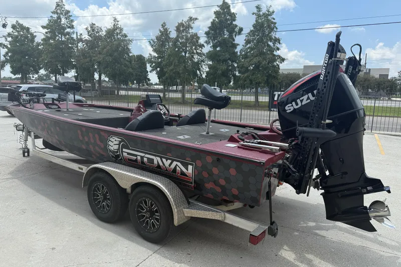 Slide: The Image of 2021 SeaArk BC 210 boat with Suzuki engine on a trailer, parked outdoors. - 4