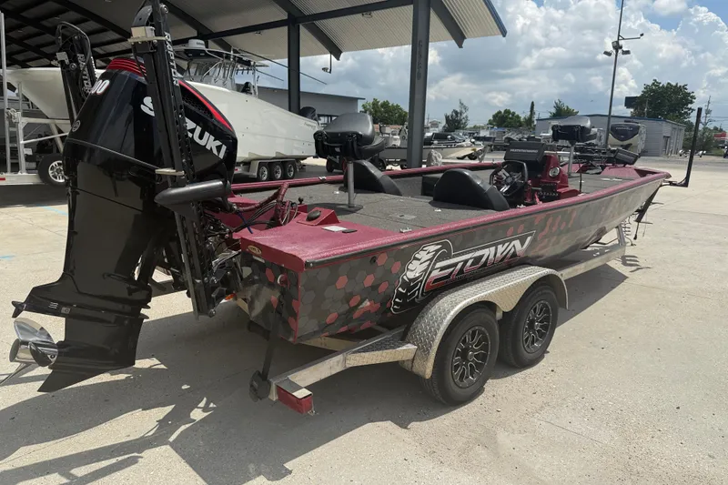 Slide: The Image of 2021 SeaArk BC 210 boat with Suzuki engine on a trailer, parked outdoors. - 6