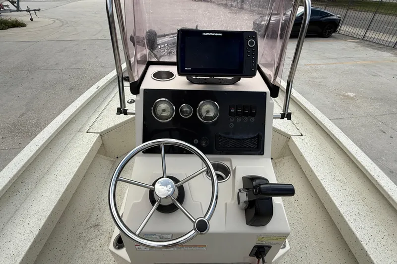 Slide: The Image of 2020 Xpress H20B boat console with steering wheel, gauges, and navigation system. - 11