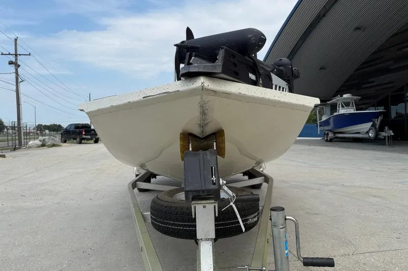 Slide: The Image of 2020 Xpress H20B boat on trailer, parked outside a building. - 2