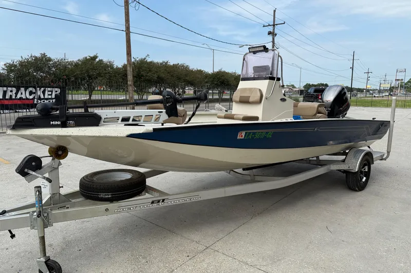 Slide: The Image of 2020 Xpress H20B boat on trailer, parked outdoors, featuring a sleek design and modern equipment. - 3