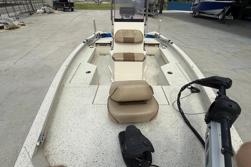 Slide: The Image of 2020 Xpress H20B boat interior with beige seating and steering controls. - 8