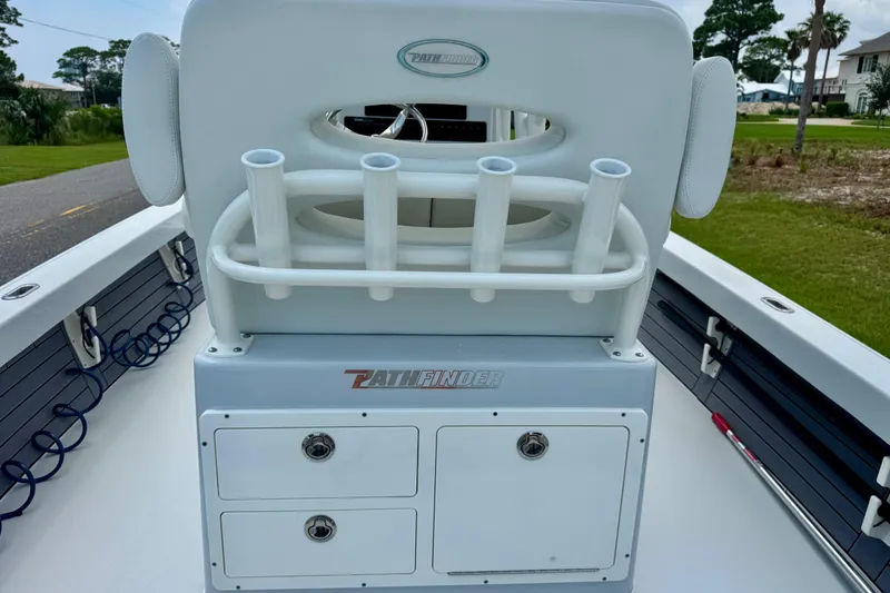 Slide: The Image of 2023 Pathfinder 2500 Hybrid boat interior with rod holders and storage compartments. - 10