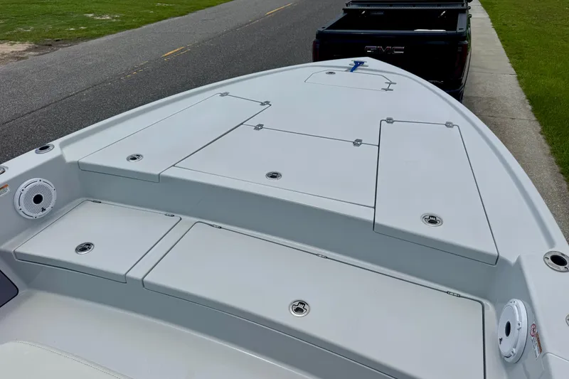 Slide: The Image of 2023 Pathfinder 2500 Hybrid boat deck, parked near a GMC truck on a road. - 13