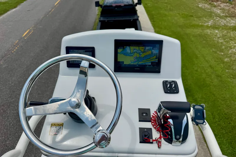 Slide: The Image of 2023 Pathfinder 2500 Hybrid boat console with steering wheel and navigation display. - 16