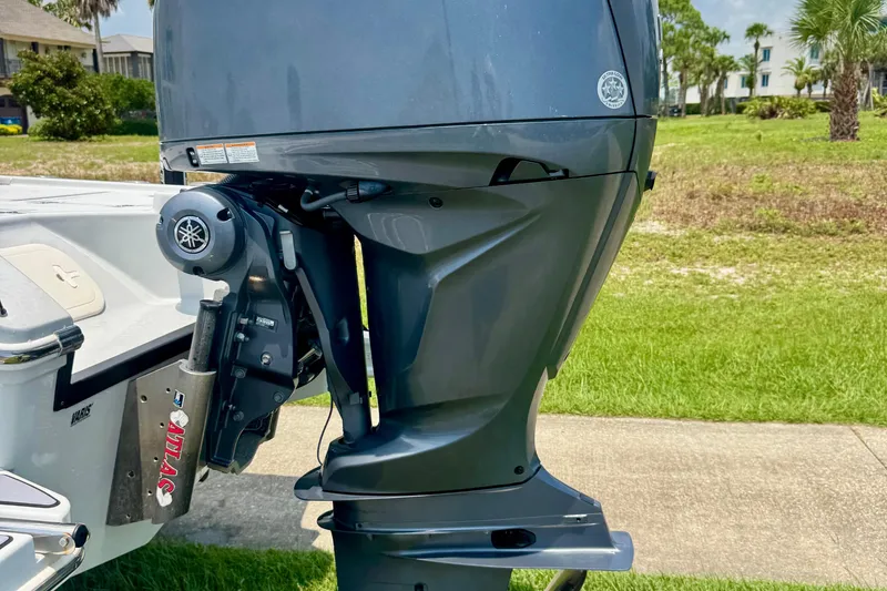 Slide: The Image of 2023 Pathfinder 2500 Hybrid boat with Yamaha outboard motor, parked on grass. - 4