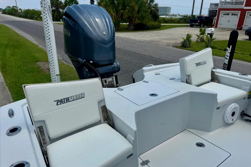 Slide: The Image of 2023 Pathfinder 2500 Hybrid boat with Yamaha outboard motor, parked near a road. - 8