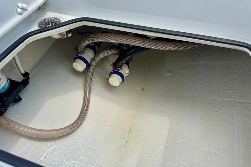Slide: The Image of 2023 Pathfinder 2500 Hybrid boat bilge area with hoses and fittings. - 9