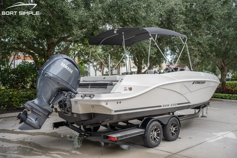 Slide: The Image of 2023 Starcraft SVX 231 OB DH boat with Yamaha outboard motor on trailer. - 4