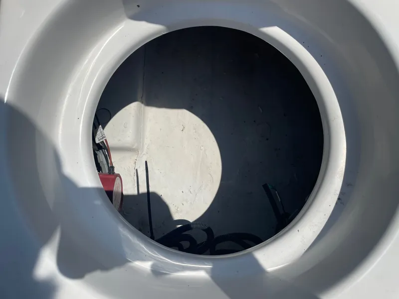 Slide: The Image of 2024 NauticStar 211 Hybrid boat storage compartment with visible wiring and equipment. - 14