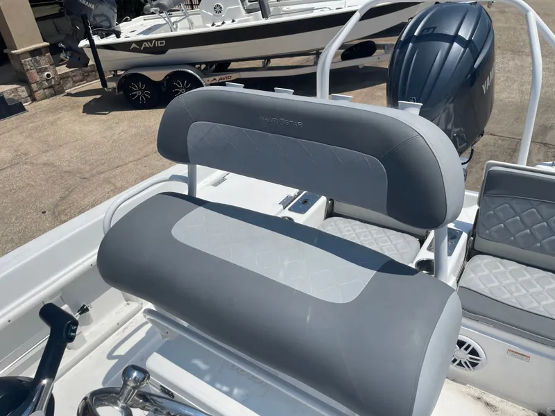 Slide: The Image of 2024 NauticStar 211 Hybrid boat interior with gray seating and Yamaha engine. - 15