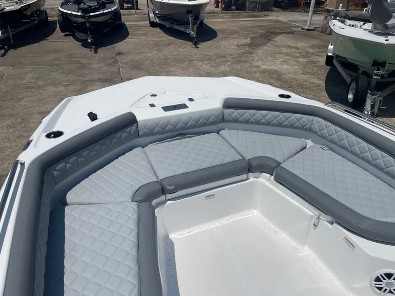 Slide: The Image of 2024 NauticStar 211 Hybrid boat with gray cushioned seating in the bow area. - 21