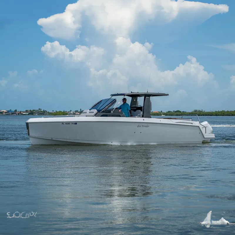 The Image of 2023 Schaefer V33 boat cruising on calm waters under a blue sky. - 0