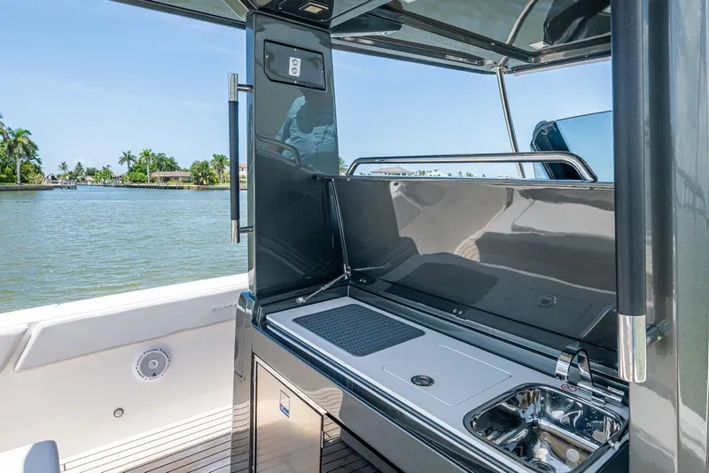 Slide: The Image of 2023 Schaefer V33 yacht with sleek outdoor kitchen and scenic water view. - 10