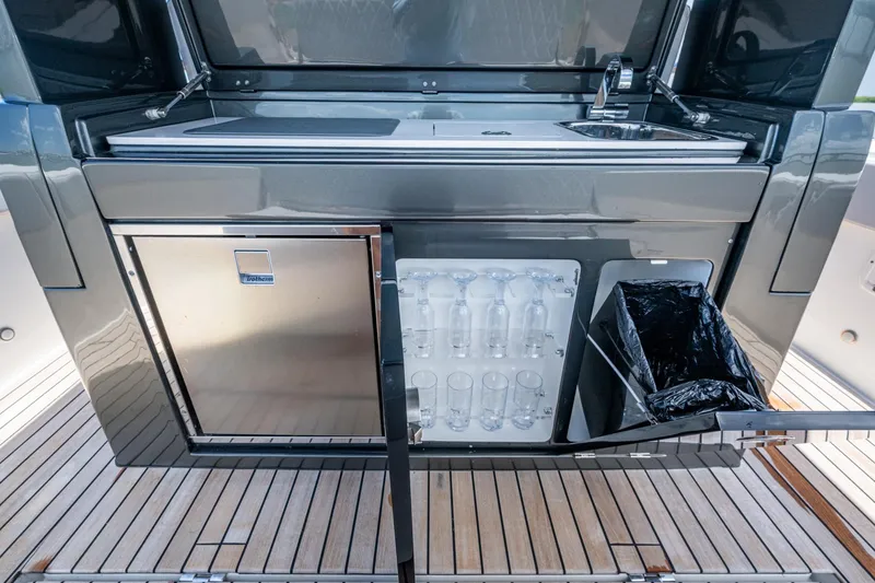Slide: The Image of Outdoor kitchen on 2023 Schaefer V33 yacht with sink, fridge, and glass storage. - 11