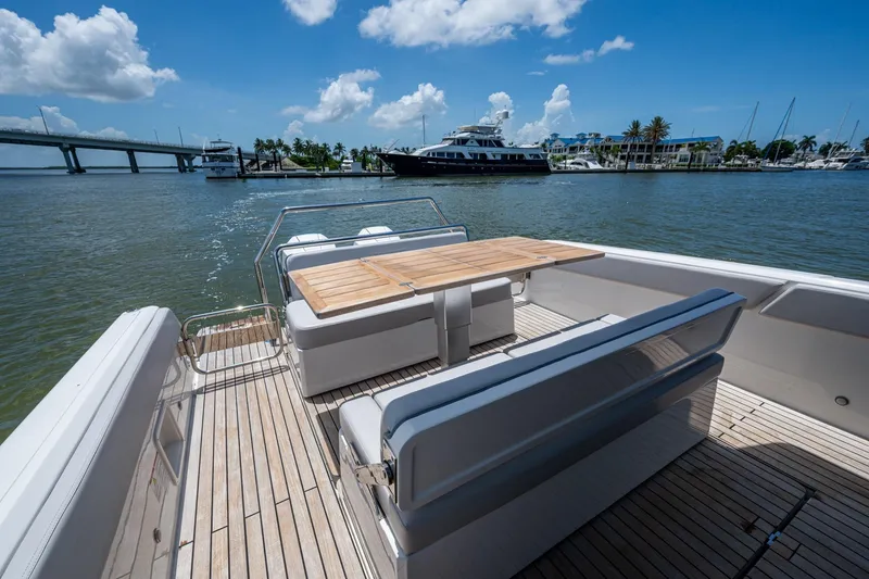 Slide: The Image of 2023 Schaefer V33 yacht deck with seating and table, overlooking marina and bridge. - 17