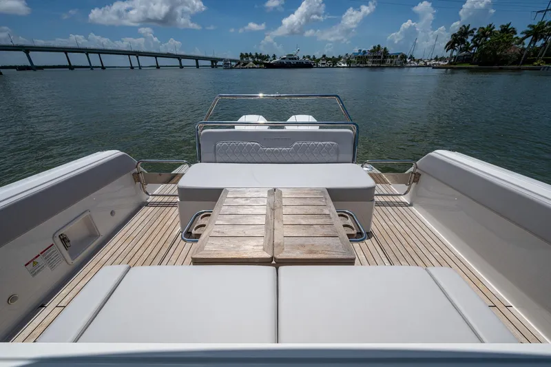Slide: The Image of 2023 Schaefer V33 yacht deck with seating, table, and scenic water view. - 19