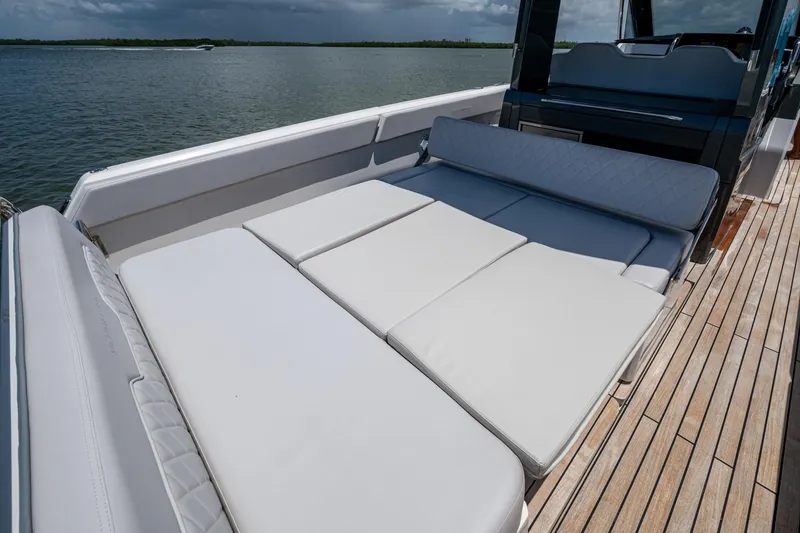 Slide: The Image of 2023 Schaefer V33 yacht with luxurious deck seating and scenic water view. - 20