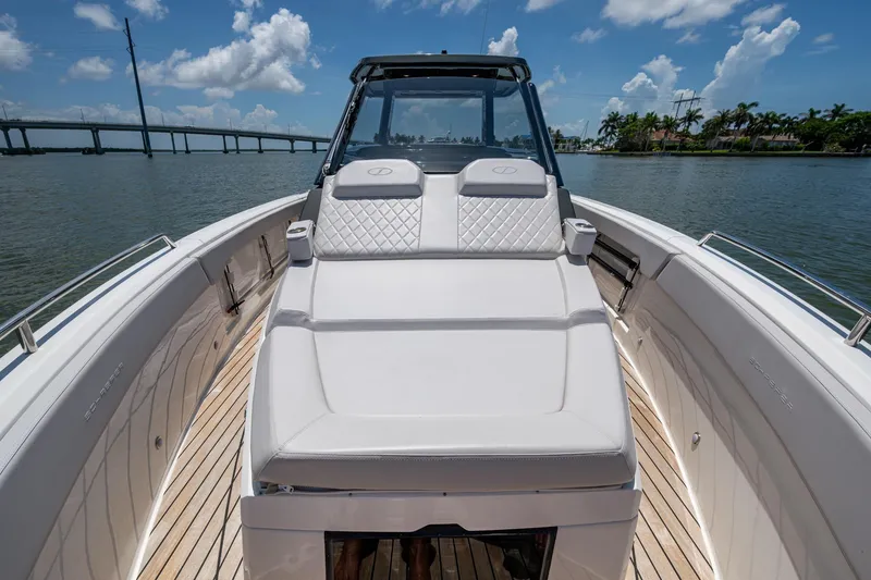 Slide: The Image of 2023 Schaefer V33 boat with luxurious seating, cruising on a sunny day near a bridge. - 22