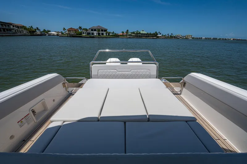 Slide: The Image of 2023 Schaefer V33 boat with spacious sun deck, overlooking serene waterfront homes. - 24