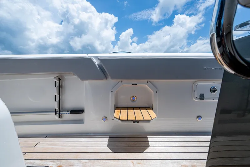 Slide: The Image of 2023 Schaefer V33 boat deck with wooden flooring and clear blue sky. - 25