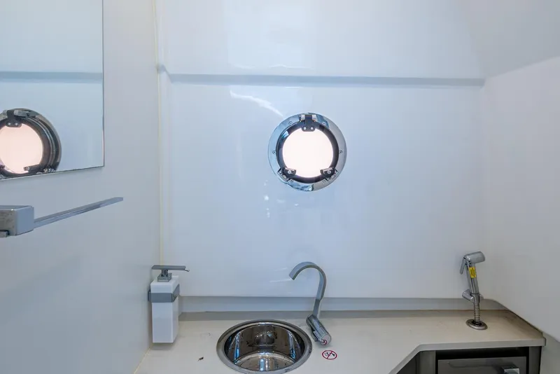 Slide: The Image of 2023 Schaefer V33 yacht interior with porthole, sink, and modern fixtures. - 32