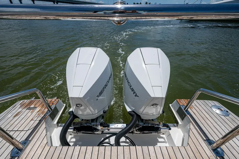 Slide: The Image of Twin Mercury outboard engines on 2023 Schaefer V33 boat, cruising on water. - 35
