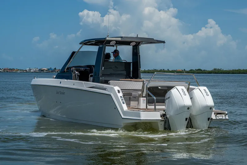 Slide: The Image of 2023 Schaefer V33 boat cruising on calm waters under a clear blue sky. - 37